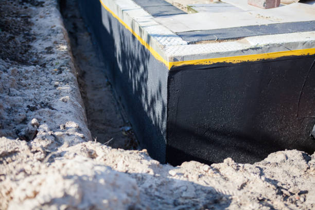 Professional Basement Waterproofing technician working in Athens, IL